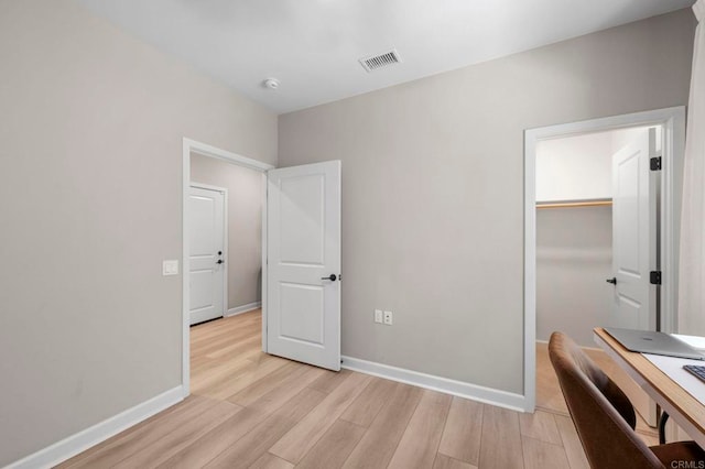 7902 Belluno Way, San Diego, CA 92126 - unfurnished bedroom featuring light wood-type flooring, baseboards, a desk, and a closet