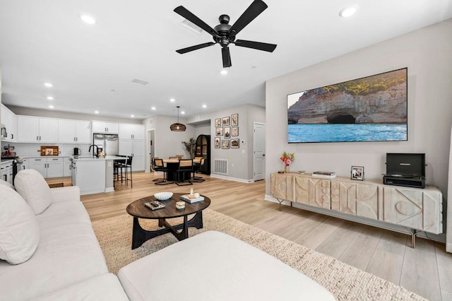 7902 Belluno Way, San Diego, CA 92126 - living area with light wood finished floors, ceiling fan, recessed lighting, and baseboards