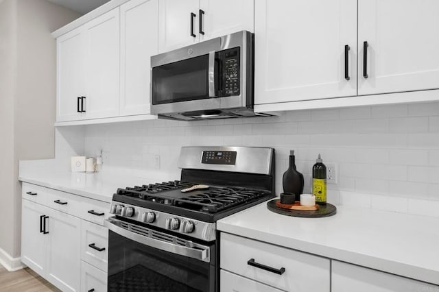 7902 Belluno Way, San Diego, CA 92126 - kitchen with appliances with stainless steel finishes, light countertops, decorative backsplash, and white cabinetry