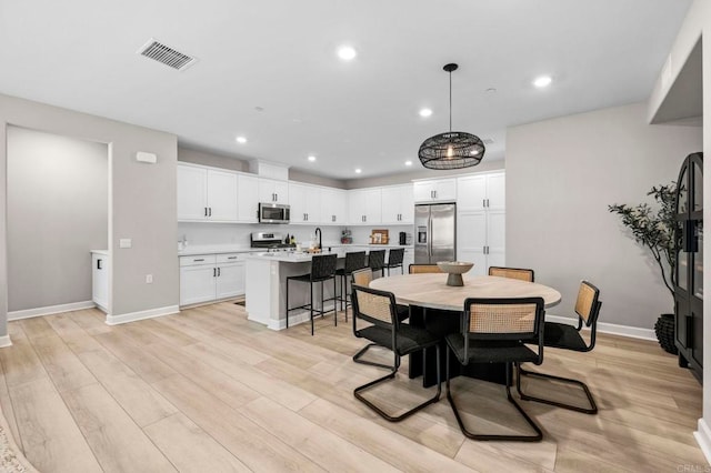 7902 Belluno Way, San Diego, CA 92126 - dining space with recessed lighting, baseboards, and light wood-style flooring