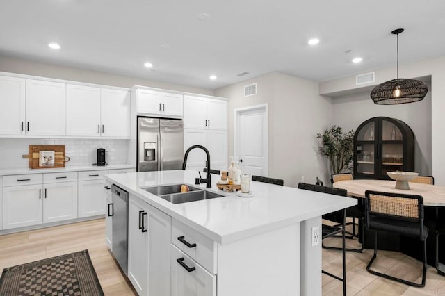 7902 Belluno Way, San Diego, CA 92126 - kitchen with appliances with stainless steel finishes, a sink, light countertops, recessed lighting, and decorative light fixtures