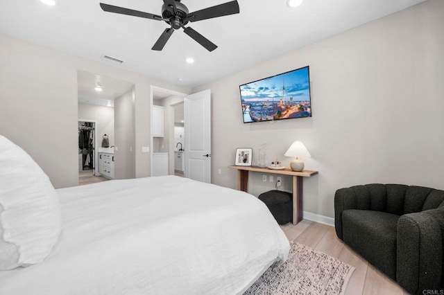 7902 Belluno Way, San Diego, CA 92126 - bedroom featuring light wood-style floors, recessed lighting, baseboards, ceiling fan, and a spacious closet