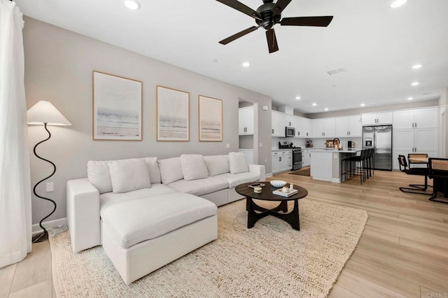 7902 Belluno Way, San Diego, CA 92126 - living area featuring a ceiling fan, recessed lighting, light wood-style floors, and baseboards