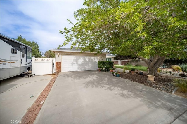 43220 51st St W, Quartz Hill, CA 93536 - view of front of house featuring driveway, brick siding, and an attached garage