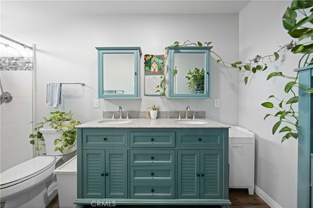 43220 51st St W, Quartz Hill, CA 93536 - full bathroom featuring toilet, double vanity, tiled shower, and wood finished floors