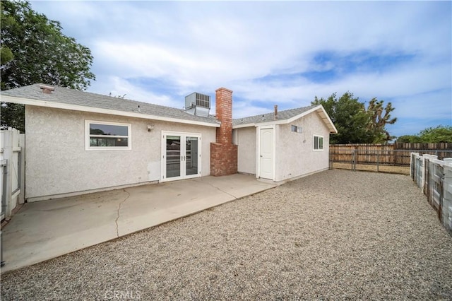 43220 51st St W, Quartz Hill, CA 93536 - rear view of property featuring stucco siding, a fenced backyard, a patio area, central AC, and a chimney