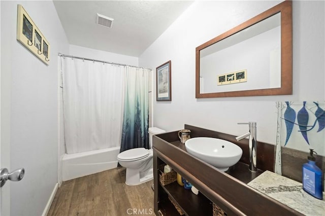 43220 51st St W, Quartz Hill, CA 93536 - bathroom with wood finished floors, toilet, vanity, and shower / bath combination with curtain