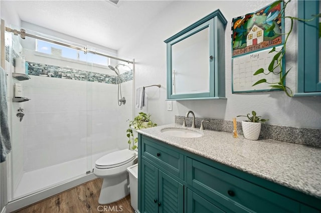 43220 51st St W, Quartz Hill, CA 93536 - bathroom featuring toilet, wood finished floors, a stall shower, and vanity