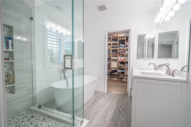 28217 Alton Way, Castaic, CA 91384 - bathroom with a walk in closet, a freestanding tub, double vanity, and a shower stall