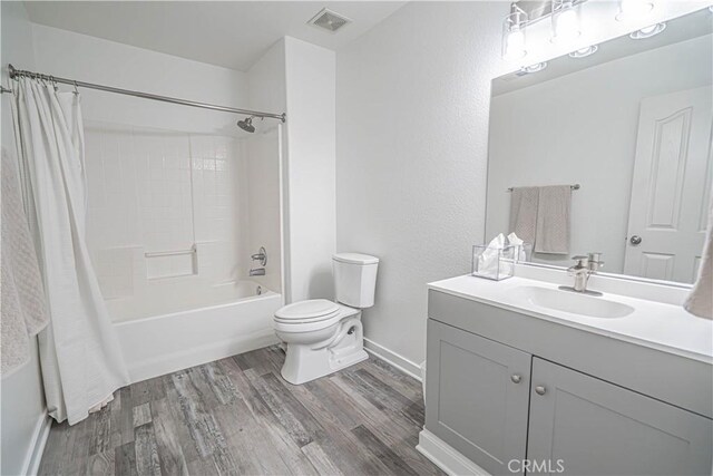 28217 Alton Way, Castaic, CA 91384 - bathroom with vanity, wood finished floors, shower / bathtub combination with curtain, toilet, and baseboards