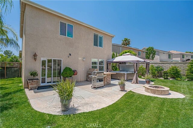 28217 Alton Way, Castaic, CA 91384 - back of property with a patio area, a fire pit, stucco siding, and a gazebo