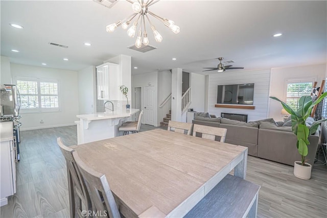 28217 Alton Way, Castaic, CA 91384 - dining space featuring stairs, light wood-style floors, a chandelier, baseboards, and recessed lighting