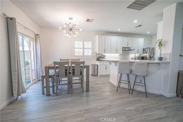 28217 Alton Way, Castaic, CA 91384 - dining room with healthy amount of natural light, a chandelier, recessed lighting, baseboards, and light wood-type flooring