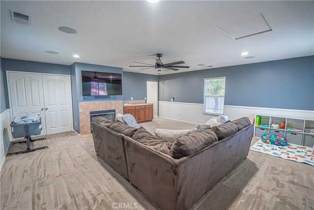 28217 Alton Way, Castaic, CA 91384 - living area with a ceiling fan, a tile fireplace, recessed lighting, attic access, and a wainscoted wall