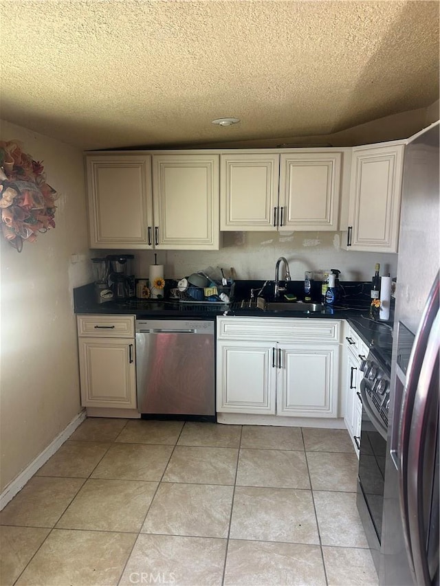 15533 Louise St, Victorville, CA 92395 - kitchen featuring stainless steel dishwasher, stove, a sink, a textured ceiling, and dark countertops
