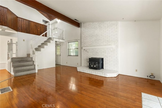 2631 San Jose St, Chico, CA 95973 - unfurnished living room with wood finished floors, stairway, and a wood stove