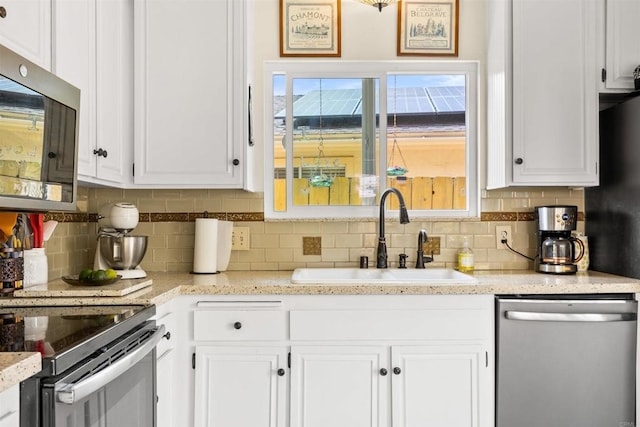6544 Camino Del Parque, Carlsbad, CA 92011 - kitchen featuring appliances with stainless steel finishes, a sink, decorative backsplash, and white cabinets