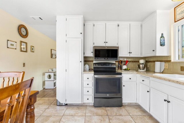6544 Camino Del Parque, Carlsbad, CA 92011 - kitchen with stainless steel appliances, decorative backsplash, white cabinetry, light tile patterned flooring, and a sink