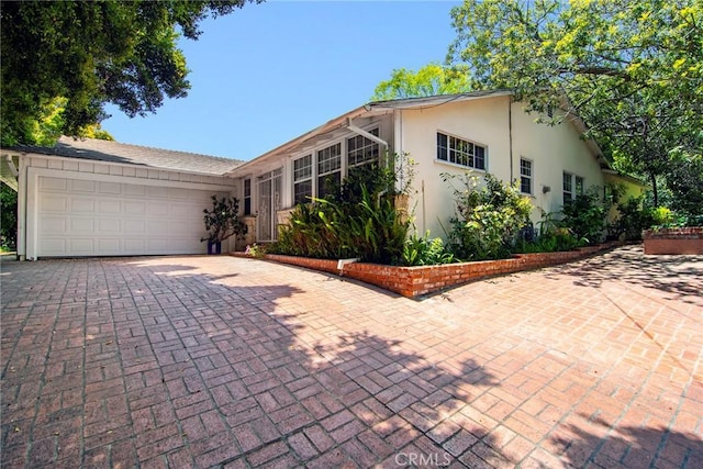 2363 Coldwater Canyon Dr, Beverly Hills, CA 90210 - single story home with decorative driveway, stucco siding, and an attached garage