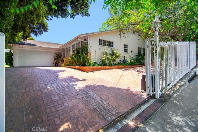 2363 Coldwater Canyon Dr, Beverly Hills, CA 90210 - view of front of property featuring stucco siding, driveway, and a garage