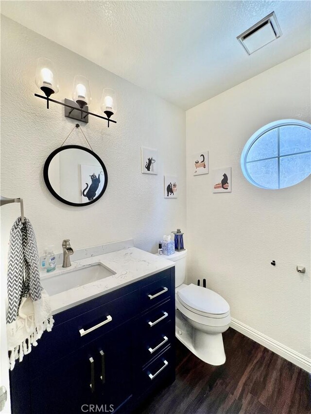29403 Clear View Ln, Highland, CA 92346 - bathroom with wood finished floors, vanity, toilet, baseboards, and a textured ceiling