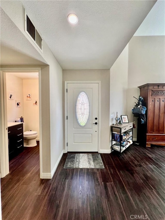 29403 Clear View Ln, Highland, CA 92346 - foyer featuring dark wood-type flooring, baseboards, and a textured ceiling