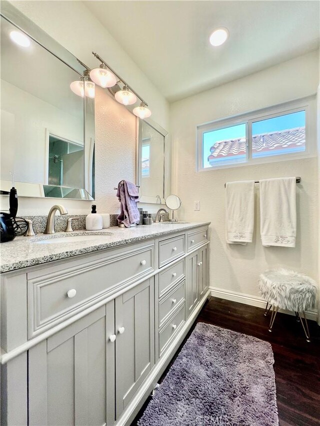29403 Clear View Ln, Highland, CA 92346 - bathroom with double vanity, wood finished floors, baseboards, and recessed lighting