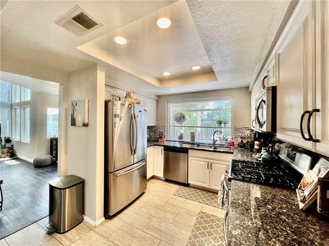 29403 Clear View Ln, Highland, CA 92346 - kitchen featuring stainless steel appliances, a sink, a textured ceiling, backsplash, and white cabinets