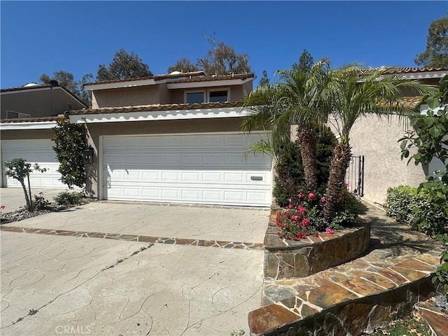 23128 Park Sorrento, Calabasas, CA 91302 - view of front facade with stucco siding, driveway, and an attached garage