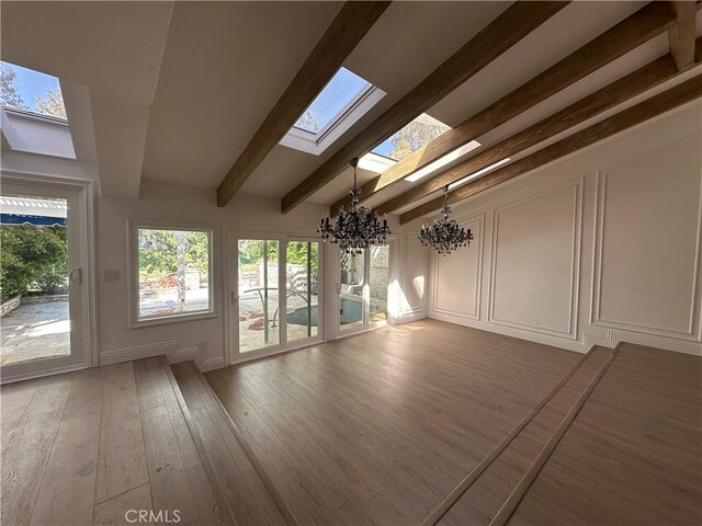 23128 Park Sorrento, Calabasas, CA 91302 - unfurnished sunroom featuring a chandelier, a skylight, and beamed ceiling