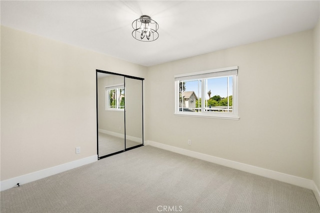 1917 N Quince Way, Upland, CA 91784 - unfurnished bedroom featuring light carpet, a chandelier, and baseboards