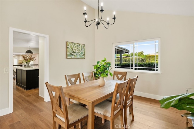 1917 N Quince Way, Upland, CA 91784 - dining space featuring a chandelier, baseboards, light wood finished floors, and high vaulted ceiling