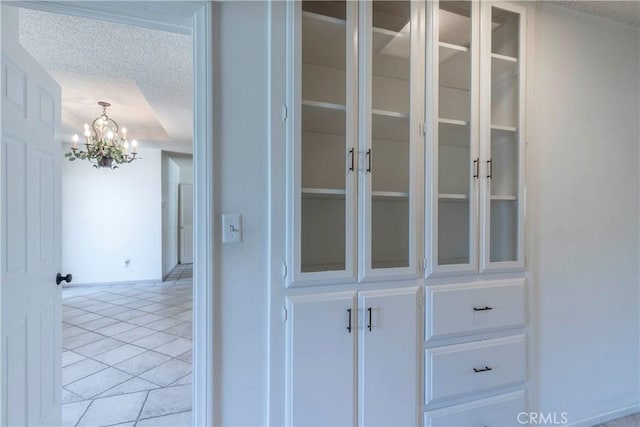 11829 Balboa Blvd, Granada Hills, CA 91344 - detailed view of a chandelier, a textured ceiling, and baseboards