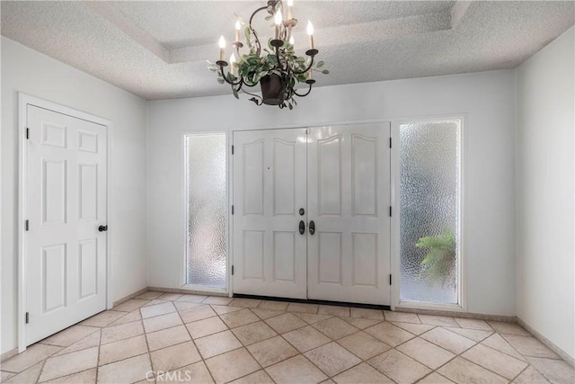 11829 Balboa Blvd, Granada Hills, CA 91344 - foyer entrance featuring a chandelier, a textured ceiling, baseboards, and light tile patterned floors