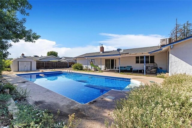 2192 Beverly Ave, Clovis, CA 93611 - view of swimming pool featuring a patio area and central AC unit