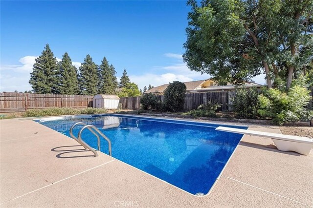 2192 Beverly Ave, Clovis, CA 93611 - view of swimming pool with a diving board, a fenced backyard, and a patio