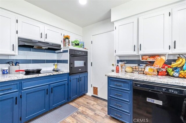 2192 Beverly Ave, Clovis, CA 93611 - kitchen with black appliances, blue cabinetry, under cabinet range hood, and white cabinets