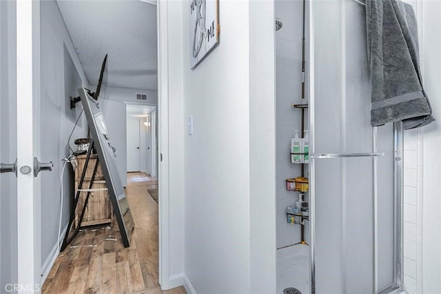 2192 Beverly Ave, Clovis, CA 93611 - corridor with light wood finished floors, a textured ceiling, and baseboards