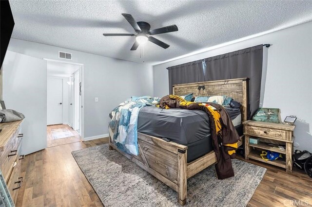 2192 Beverly Ave, Clovis, CA 93611 - bedroom with a textured ceiling, wood finished floors, and a ceiling fan