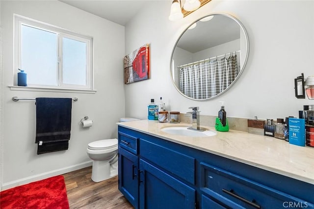 2192 Beverly Ave, Clovis, CA 93611 - bathroom featuring vanity, toilet, wood finished floors, and baseboards