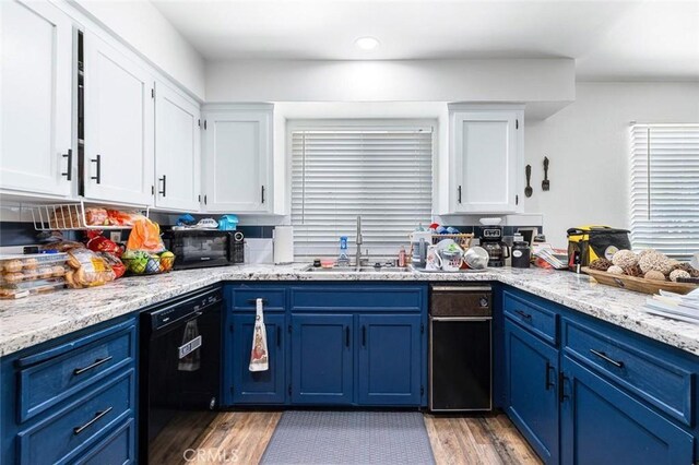 2192 Beverly Ave, Clovis, CA 93611 - kitchen with blue cabinetry, black appliances, a sink, white cabinetry, and light wood-type flooring