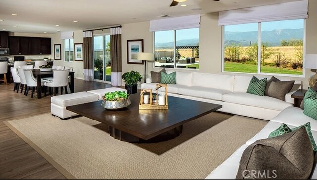 36895 Cascina Ln, Beaumont, CA 92223 - living area with dark wood-style floors, a mountain view, ceiling fan, and recessed lighting