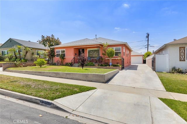 11422 Charlesworth Rd, Santa Fe Springs, CA 90670 - view of front of home with a front yard, a garage, stucco siding, and an outdoor structure