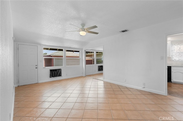 11422 Charlesworth Rd, Santa Fe Springs, CA 90670 - unfurnished room featuring ceiling fan, plenty of natural light, light tile patterned flooring, a textured ceiling, and heating unit