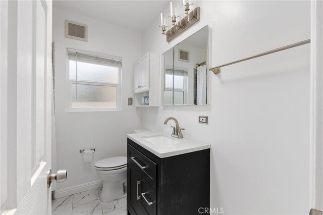 11422 Charlesworth Rd, Santa Fe Springs, CA 90670 - bathroom with toilet, vanity, marble look tiles, and baseboards