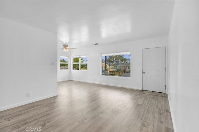 11422 Charlesworth Rd, Santa Fe Springs, CA 90670 - spare room with light wood finished floors, a ceiling fan, and baseboards