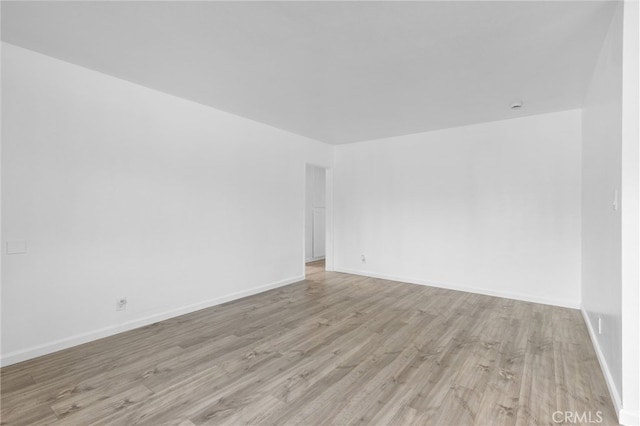 11422 Charlesworth Rd, Santa Fe Springs, CA 90670 - spare room featuring light wood-style flooring and baseboards