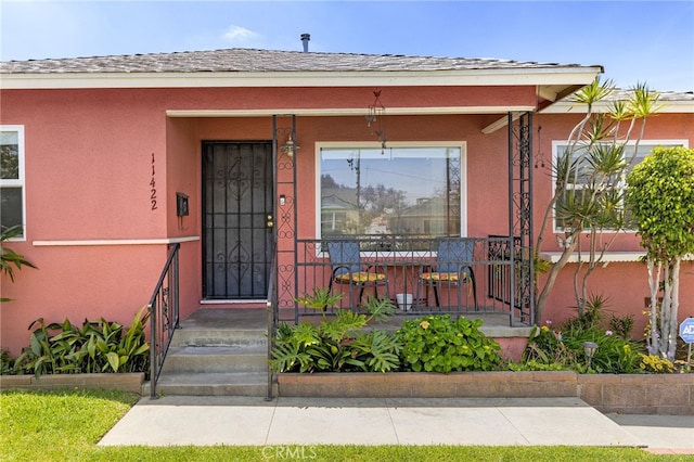 11422 Charlesworth Rd, Santa Fe Springs, CA 90670 - view of exterior entry featuring stucco siding and a porch