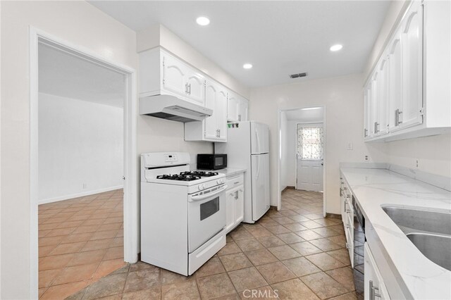 11422 Charlesworth Rd, Santa Fe Springs, CA 90670 - kitchen with white appliances, under cabinet range hood, white cabinetry, light stone countertops, and recessed lighting