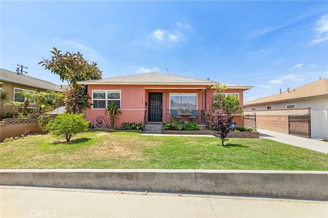 11422 Charlesworth Rd, Santa Fe Springs, CA 90670 - view of front of home with stucco siding, a gate, and covered porch